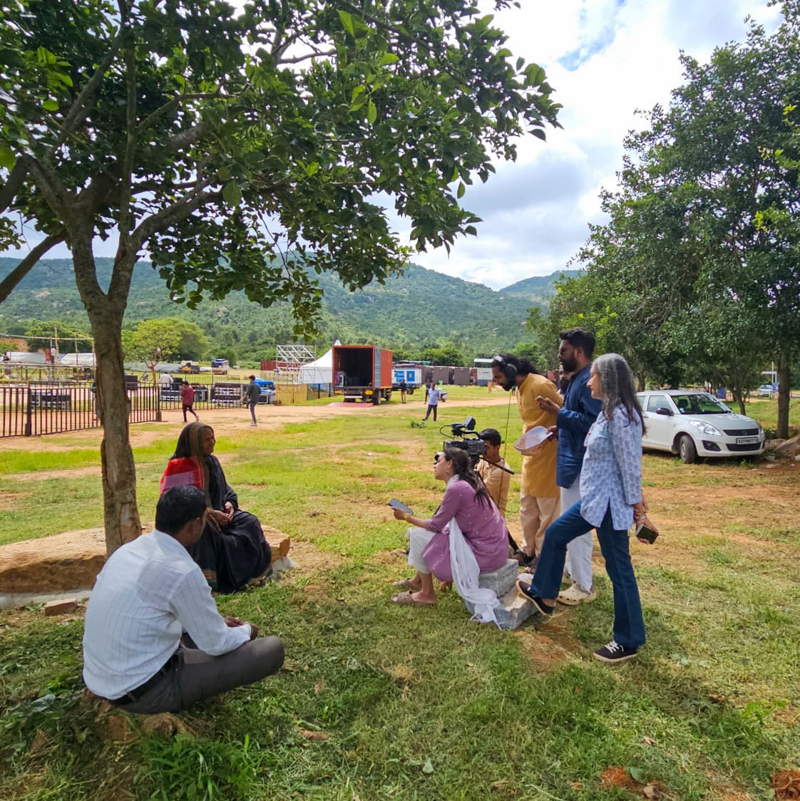 Crew and villagers gathered on the field between takes